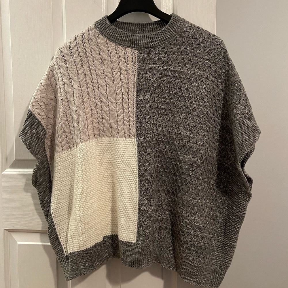 NWOT. Women’s color block cape sweater. Never worn. Size large.